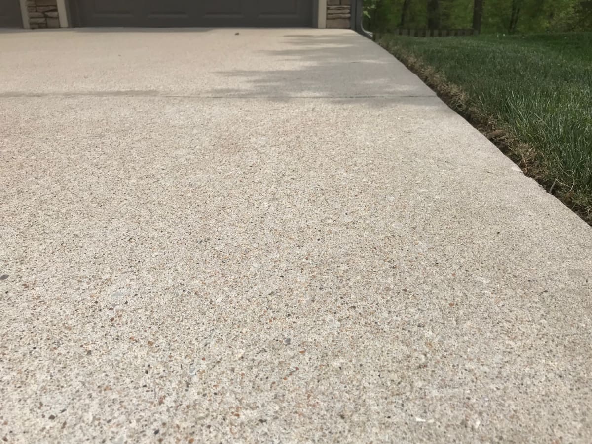 The same concrete driveway after hot water concrete cleaning, even and light
