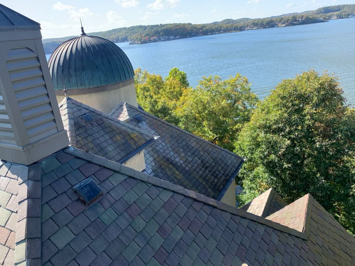 Roof cleaning on a lake home roof with the Lake of the Ozarks in view