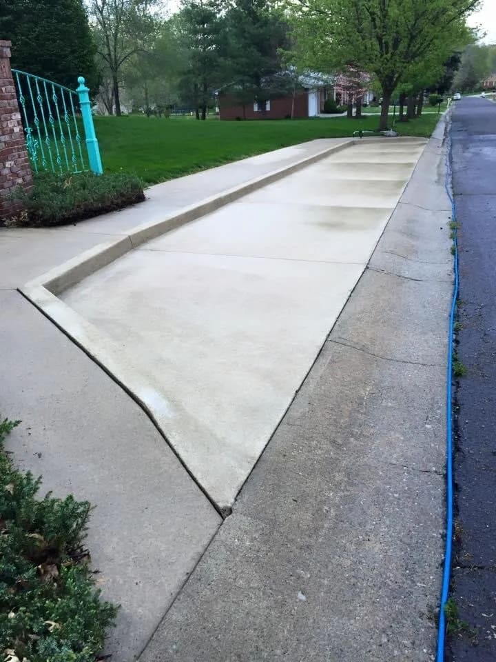 The same sidewalk and curb after concrete cleaning, clean and light