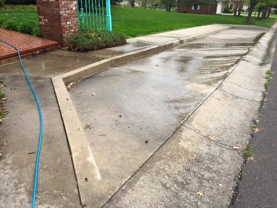 Sidewalk and curb dark with grime before concrete cleaning